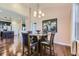 Bright dining room with glass table and four chairs, kitchen view at 6655 S Shawnee St, Aurora, CO 80016
