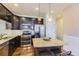 Open kitchen with granite countertops and island at 6655 S Shawnee St, Aurora, CO 80016