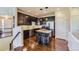 Kitchen with dark cabinets, granite counters, and island at 6655 S Shawnee St, Aurora, CO 80016