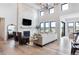 Elegant living room with stone fireplace, hardwood floors and large windows at 5300 Soledad Cir, Parker, CO 80134