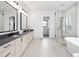 Main bathroom with double vanities, a soaking tub, and a walk-in shower at 5300 Soledad Cir, Parker, CO 80134