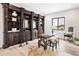 Home office with built-in wooden shelving and a large work table at 5300 Soledad Cir, Parker, CO 80134