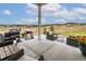 Outdoor patio with seating area and grill, overlooking scenic landscape at 5300 Soledad Cir, Parker, CO 80134