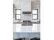 Modern kitchen with white cabinets, gas cooktop, and a large island at 5300 Soledad Cir, Parker, CO 80134
