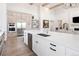 Modern kitchen island with sink, dishwasher, and white cabinetry at 5300 Soledad Cir, Parker, CO 80134
