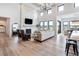 Open concept living room with a stone fireplace and hardwood floors at 5300 Soledad Cir, Parker, CO 80134