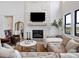 Comfortable living room with a stone fireplace and large windows at 5300 Soledad Cir, Parker, CO 80134