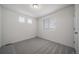 Bright bedroom with gray carpeting and two windows at 13448 E 103Rd Pl, Commerce City, CO 80022