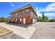 Two-story building with brick and siding exterior, attached garage, and ample parking at 9947 Croke Dr, Denver, CO 80260