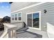 Backyard deck with sliding glass door, overlooking a dirt pile and a few houses at 7480 E 158Th Pl, Thornton, CO 80602