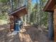 Covered outdoor kitchen with built-in grill and seating area at 9719 Beaver Pond, Conifer, CO 80433