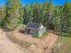 Secluded log cabin with solar panels in a wooded area at 9719 Beaver Pond, Conifer, CO 80433