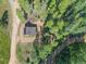 Aerial view of a cabin with solar panels and surrounding trees at 9719 Beaver Pond, Conifer, CO 80433