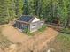 Aerial view of a rustic log cabin with solar panels at 9719 Beaver Pond, Conifer, CO 80433