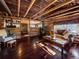 Cozy living room in a log cabin with wood floors and wood stove at 9719 Beaver Pond, Conifer, CO 80433