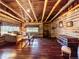 Cozy living room features wood walls, exposed beams, and a wood burning stove at 9719 Beaver Pond, Conifer, CO 80433