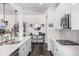 Modern kitchen with white cabinets, quartz countertops, and stainless steel appliances at 19064 W 95Th Ln, Arvada, CO 80007