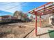 Backyard with patio cover, fire pit, and ample space at 7887 Quivas Way, Denver, CO 80221