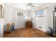 Bedroom with hardwood floors, ceiling fan, and ample natural light at 7887 Quivas Way, Denver, CO 80221