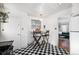 Kitchen with breakfast bar and black and white checkered floor at 7887 Quivas Way, Denver, CO 80221