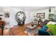 Open concept living room with hardwood floors and a view into the kitchen at 7887 Quivas Way, Denver, CO 80221