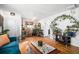 Bright living room featuring hardwood floors and eclectic decor at 7887 Quivas Way, Denver, CO 80221