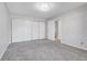 Bright bedroom with grey carpet, large closet, and access to bathroom at 7995 E Mississippi Ave # C6, Denver, CO 80247