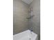 Clean bathroom with a shower/tub, updated tile, and shelving at 1924 S Huron St, Denver, CO 80223