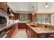 Gourmet kitchen with granite countertops, wooden cabinetry, and stainless steel appliances at 168 Corkscrew Dr, Breckenridge, CO 80424