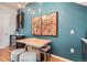 Small dining area with teal accent wall and art at 1905 Hooker St, Denver, CO 80204