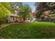 Large backyard with grassy area, patio, and screened-in porch at 9641 Sierra Dr, Arvada, CO 80005