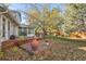 Large backyard with patio, mature trees, and a sunroom at 9641 Sierra Dr, Arvada, CO 80005