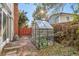 Landscaped backyard with a greenhouse and patio at 9641 Sierra Dr, Arvada, CO 80005