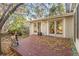 Deck and backyard with mature trees and a greenhouse at 9641 Sierra Dr, Arvada, CO 80005