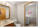 Main floor bathroom includes a vanity, toilet and laundry area at 9641 Sierra Dr, Arvada, CO 80005