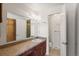 Full bathroom with vanity, toilet and a large mirror at 9641 Sierra Dr, Arvada, CO 80005