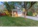 Two-story home with a brick and gray exterior, attached garage, and lush landscaping at 9641 Sierra Dr, Arvada, CO 80005