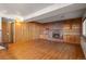 Spacious Gathering room boasts a brick fireplace and built-in shelving at 9641 Sierra Dr, Arvada, CO 80005