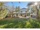 Back exterior view, showcasing a two-story home and a large yard at 9641 Sierra Dr, Arvada, CO 80005