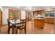 Eat-in kitchen with island, wood cabinets, and access to backyard at 9641 Sierra Dr, Arvada, CO 80005