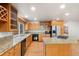 Bright kitchen features granite countertops, wood cabinets, and stainless steel appliances at 9641 Sierra Dr, Arvada, CO 80005