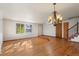 Sunlit living room with hardwood floors and a raised dining area at 9641 Sierra Dr, Arvada, CO 80005