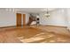 Open living room with hardwood floors, staircase, and chandelier at 9641 Sierra Dr, Arvada, CO 80005