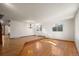 Spacious living room featuring hardwood floors and a raised dining area at 9641 Sierra Dr, Arvada, CO 80005