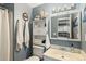 Clean bathroom with updated vanity, a linen cabinet, and shower/tub combo at 13 Nome Way # A, Aurora, CO 80012