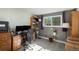 Home office with wood desk, comfortable chair, and plenty of shelving at 13 Nome Way # A, Aurora, CO 80012