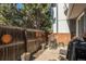 Private backyard with wooden fence, patio furniture, and grill at 13 Nome Way # A, Aurora, CO 80012