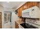 Modern kitchen with a gas range, microwave, and view to the backyard at 13 Nome Way # A, Aurora, CO 80012