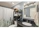 Clean bathroom with shower/tub combo, vanity, and shelving at 13 Nome Way # A, Aurora, CO 80012