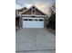 Brick house with a two-car garage and a well-maintained lawn at 4895 S Argonne St, Aurora, CO 80015